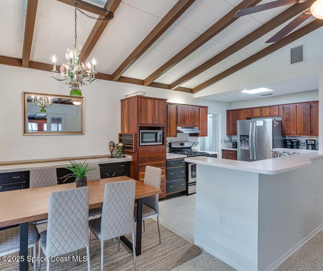 936 Santa Cruz Rd, Cocoa Beach, FL 32931 - kitchen featuring stainless steel appliances, under cabinet range hood, light countertops, a chandelier, and a peninsula