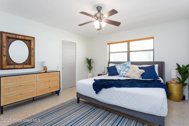 936 Santa Cruz Rd, Cocoa Beach, FL 32931 - bedroom featuring dark aggregate flooring and a ceiling fan