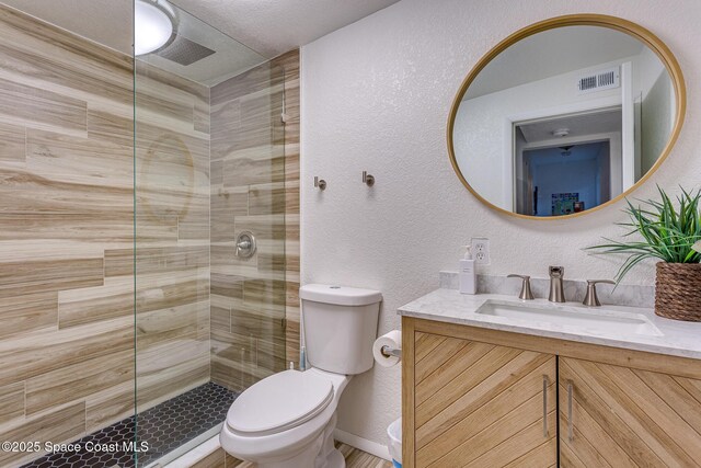 936 Santa Cruz Rd, Cocoa Beach, FL 32931 - bathroom with a textured wall, vanity, and tiled shower