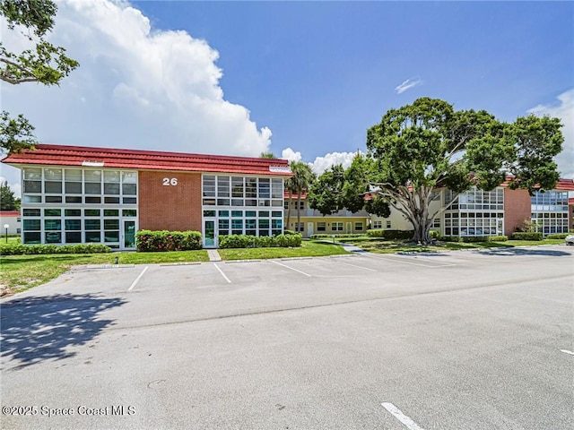 26 Pine Arbor Ln Unit 205, Vero Beach, FL 32962 - view of building exterior with uncovered parking