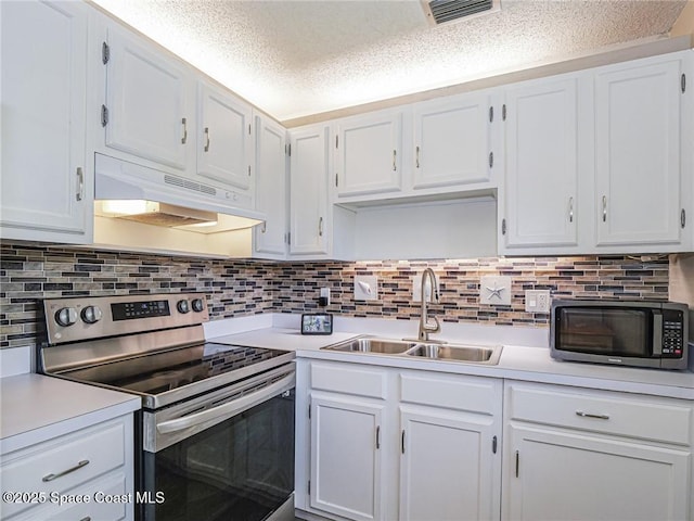 26 Pine Arbor Ln Unit 205, Vero Beach, FL 32962 - kitchen featuring electric range, under cabinet range hood, light countertops, white cabinets, and a textured ceiling