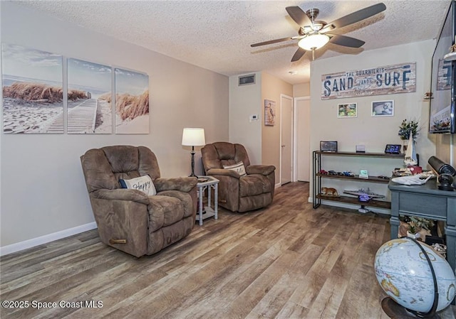 26 Pine Arbor Ln Unit 205, Vero Beach, FL 32962 - living area featuring wood finished floors, ceiling fan, and a textured ceiling
