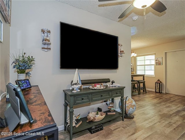 26 Pine Arbor Ln Unit 205, Vero Beach, FL 32962 - living area featuring ceiling fan, wood finished floors, and a textured ceiling