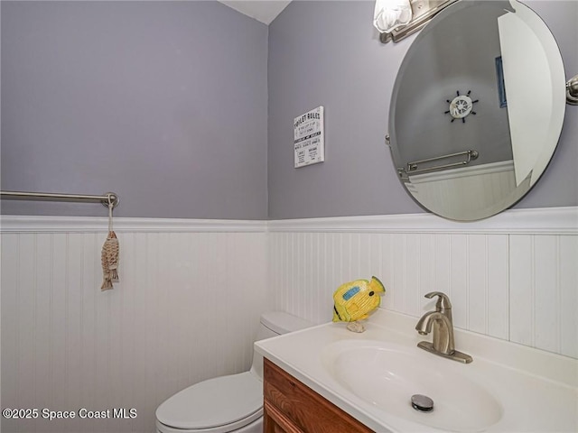 26 Pine Arbor Ln Unit 205, Vero Beach, FL 32962 - bathroom featuring wainscoting and vanity