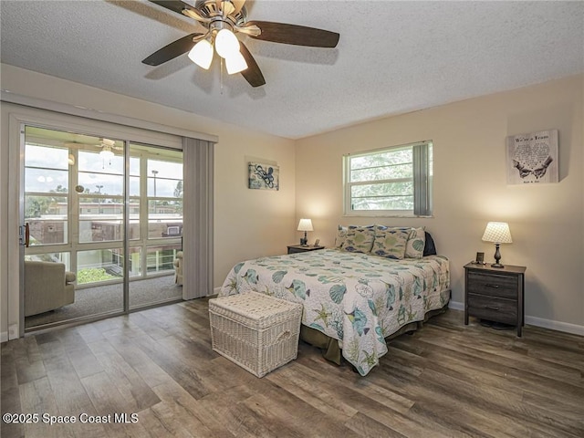 26 Pine Arbor Ln Unit 205, Vero Beach, FL 32962 - bedroom with access to exterior, wood finished floors, a textured ceiling, and ceiling fan