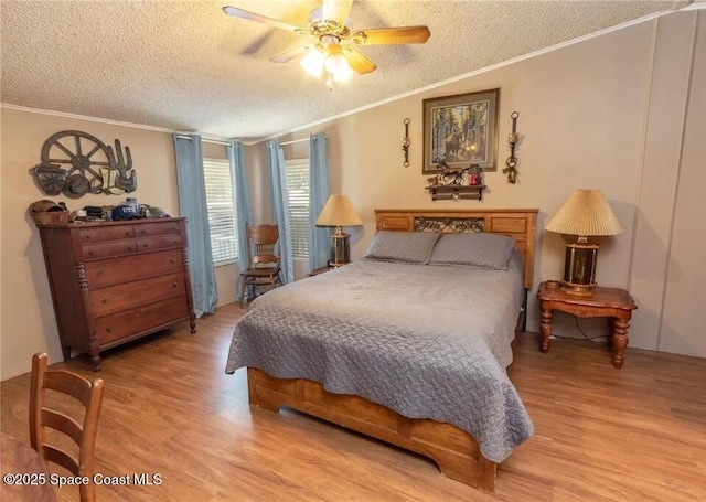 1317 Ashlee Ct, Auburndale, FL 33823 - bedroom featuring a textured ceiling, light wood-style floors, crown molding, and a ceiling fan