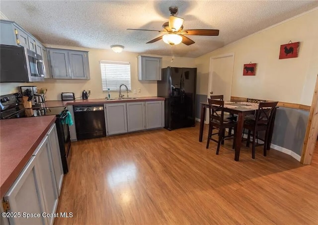 1317 Ashlee Ct, Auburndale, FL 33823 - kitchen featuring black appliances, a textured ceiling, a ceiling fan, light wood-style floors, and gray cabinets