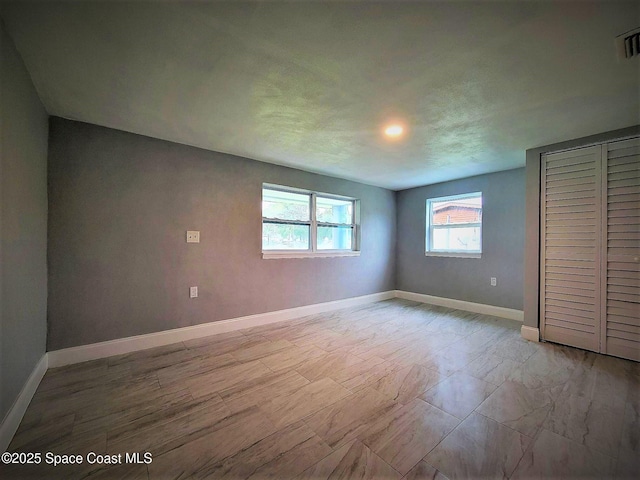 2309 Dairy Rd, Melbourne, FL 32904 - unfurnished bedroom with baseboards and a closet