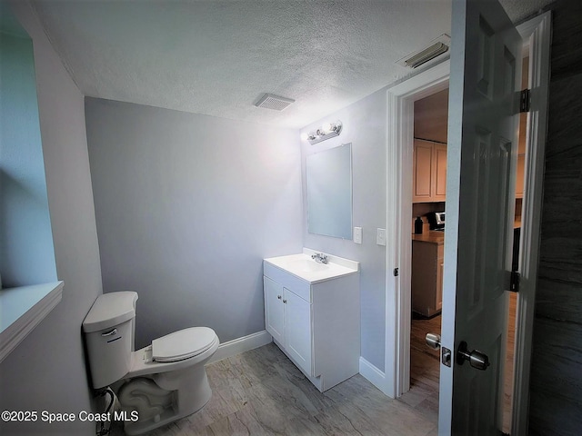 2309 Dairy Rd, Melbourne, FL 32904 - bathroom featuring vanity, a textured ceiling, and wood finished floors