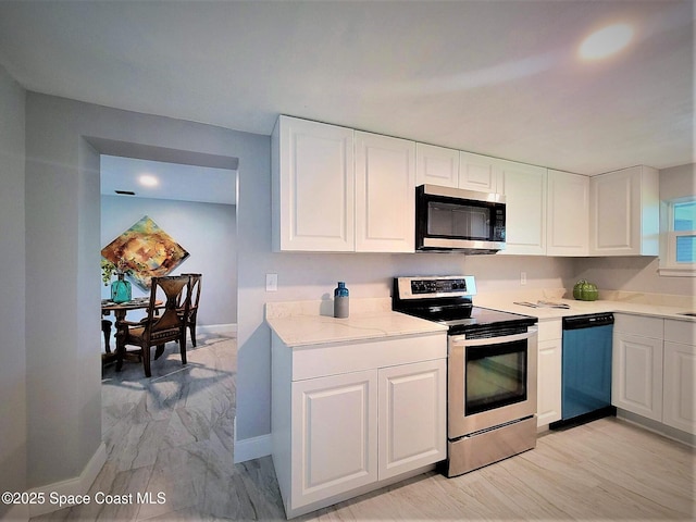 2309 Dairy Rd, Melbourne, FL 32904 - kitchen featuring appliances with stainless steel finishes and white cabinets