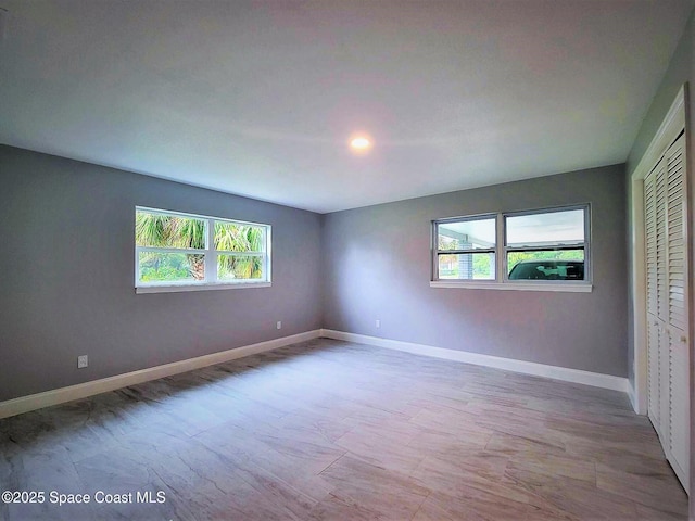 2309 Dairy Rd, Melbourne, FL 32904 - unfurnished bedroom with multiple windows and a closet