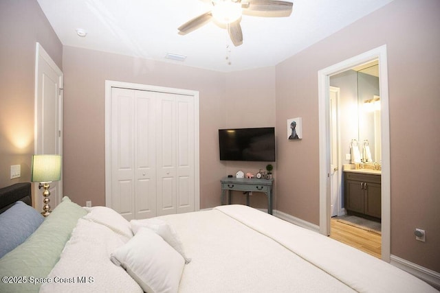 7354 Lucaya Ct, Melbourne, FL 32940 - bedroom with a closet, light wood finished floors, a ceiling fan, and ensuite bathroom