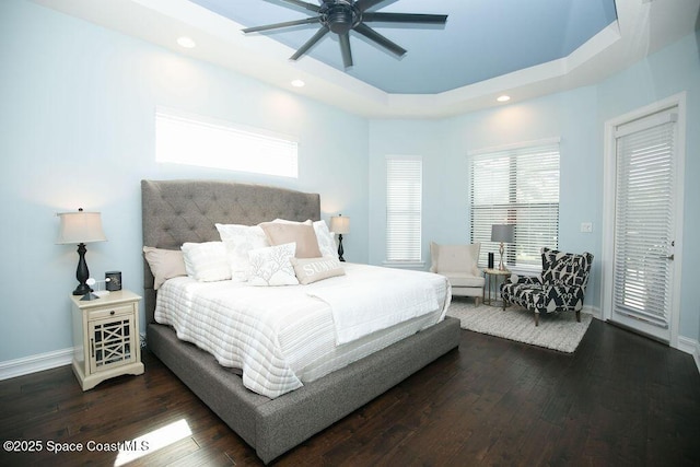 7354 Lucaya Ct, Melbourne, FL 32940 - bedroom featuring dark wood finished floors, a tray ceiling, access to outside, recessed lighting, and a ceiling fan