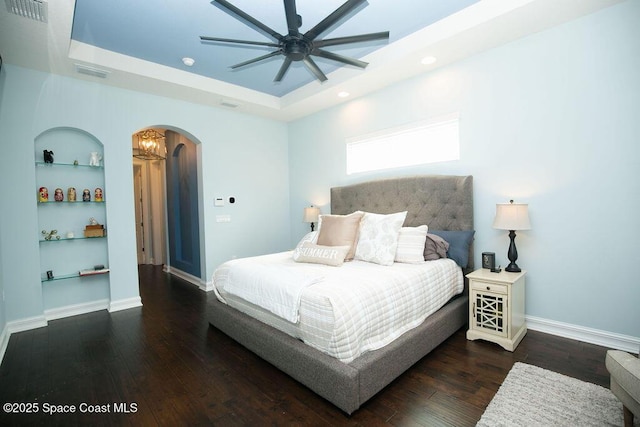 7354 Lucaya Ct, Melbourne, FL 32940 - bedroom featuring arched walkways, wood-type flooring, a raised ceiling, recessed lighting, and ceiling fan
