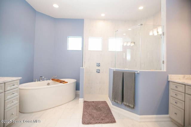 7354 Lucaya Ct, Melbourne, FL 32940 - bathroom featuring vanity, walk in shower, a freestanding bath, and recessed lighting