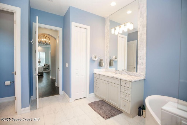 7354 Lucaya Ct, Melbourne, FL 32940 - bathroom featuring vanity, a soaking tub, recessed lighting, and a chandelier