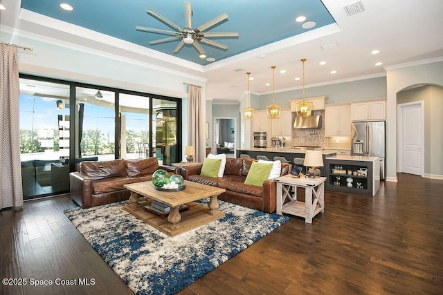 7354 Lucaya Ct, Melbourne, FL 32940 - living area featuring ceiling fan, a tray ceiling, crown molding, dark wood-style floors, and recessed lighting