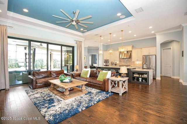 7354 Lucaya Ct, Melbourne, FL 32940 - living area with a ceiling fan, a raised ceiling, arched walkways, ornamental molding, and recessed lighting