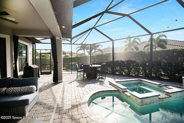 7354 Lucaya Ct, Melbourne, FL 32940 - view of pool with a patio, glass enclosure, a pool with connected hot tub, outdoor dining space, and area for grilling