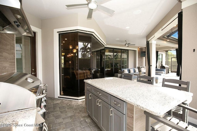 7354 Lucaya Ct, Melbourne, FL 32940 - kitchen featuring ceiling fan, range hood, gray cabinetry, light stone counters, and recessed lighting