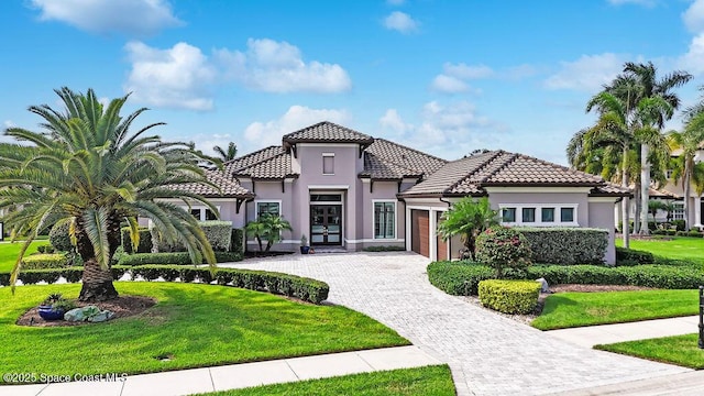 7354 Lucaya Ct, Melbourne, FL 32940 - mediterranean / spanish home with an attached garage, french doors, decorative driveway, and a front yard