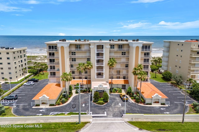 225 N Atlantic Ave Unit 603, Cocoa Beach, FL 32931 - view of apartment building / complex with uncovered parking and a water view