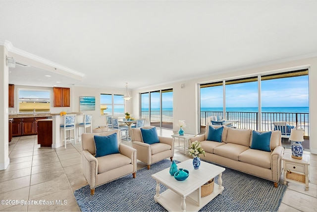 225 N Atlantic Ave Unit 603, Cocoa Beach, FL 32931 - living room featuring ornamental molding, healthy amount of natural light, a water view, and light tile patterned floors
