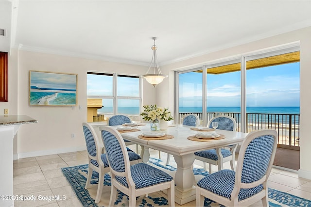 225 N Atlantic Ave Unit 603, Cocoa Beach, FL 32931 - dining space with a water view, light tile patterned flooring, and ornamental molding