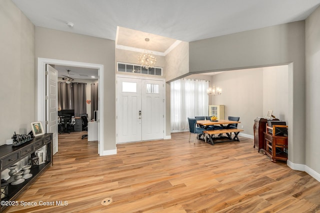 4554 Preservation Cir, Melbourne, FL 32934 - foyer entrance featuring a chandelier and light wood finished floors