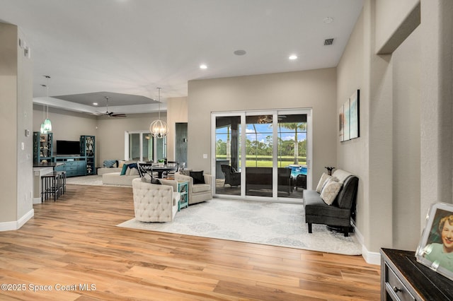 4554 Preservation Cir, Melbourne, FL 32934 - living area featuring light wood-type flooring, recessed lighting, a chandelier, and a raised ceiling