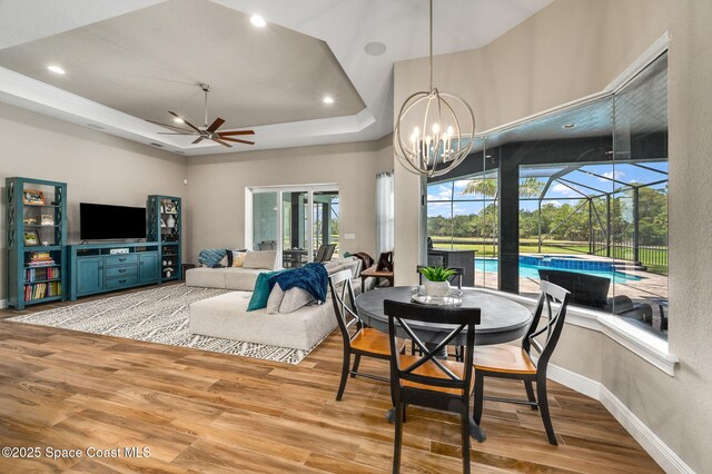 4554 Preservation Cir, Melbourne, FL 32934 - dining space featuring ceiling fan, a sunroom, wood finished floors, a chandelier, and recessed lighting