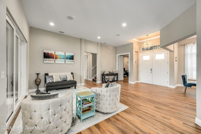4554 Preservation Cir, Melbourne, FL 32934 - living area with a chandelier, light wood-style floors, stairway, and recessed lighting