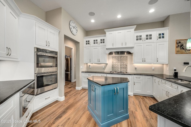 4554 Preservation Cir, Melbourne, FL 32934 - kitchen featuring appliances with stainless steel finishes, blue cabinetry, white cabinetry, light wood-type flooring, and recessed lighting