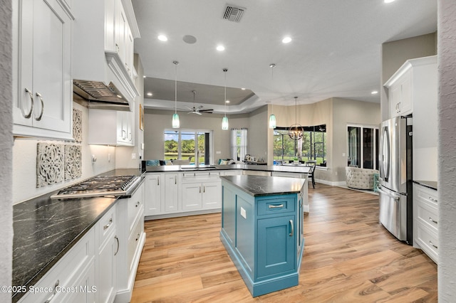 4554 Preservation Cir, Melbourne, FL 32934 - kitchen featuring stainless steel appliances, blue cabinets, recessed lighting, a peninsula, and light wood finished floors