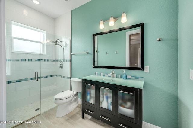 4554 Preservation Cir, Melbourne, FL 32934 - bathroom featuring a stall shower, vanity, and wood finished floors