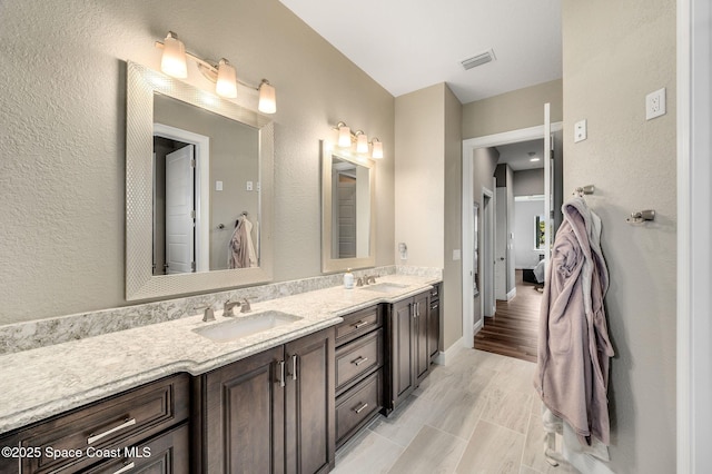 4554 Preservation Cir, Melbourne, FL 32934 - bathroom featuring double vanity and baseboards