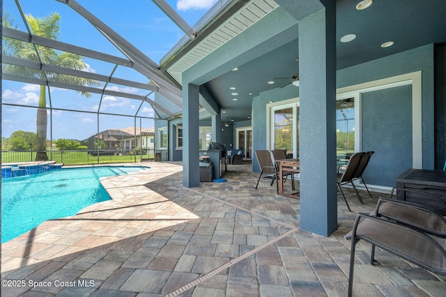 4554 Preservation Cir, Melbourne, FL 32934 - view of swimming pool featuring a ceiling fan, a patio, outdoor dining area, a pool with connected hot tub, and glass enclosure