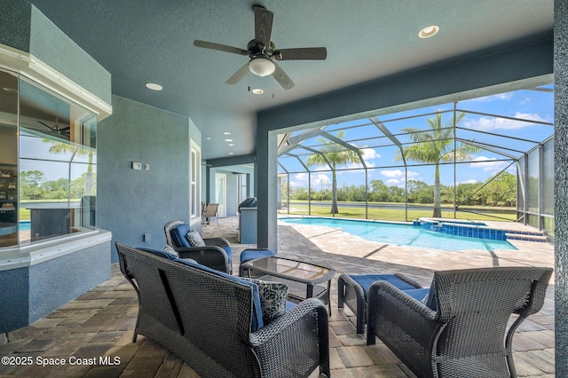 4554 Preservation Cir, Melbourne, FL 32934 - view of patio with a ceiling fan, a pool with connected hot tub, and glass enclosure