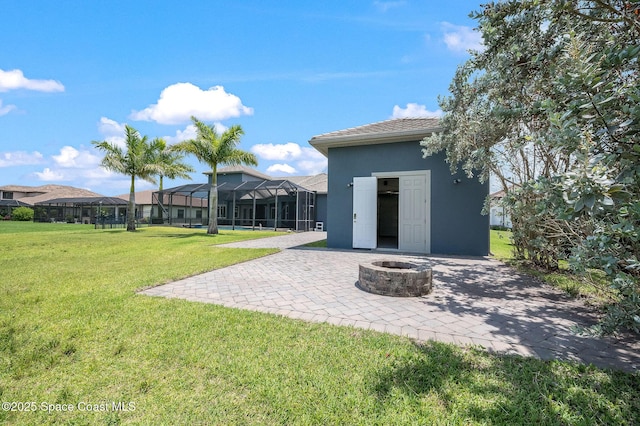 4554 Preservation Cir, Melbourne, FL 32934 - view of green lawn featuring a fire pit and a patio
