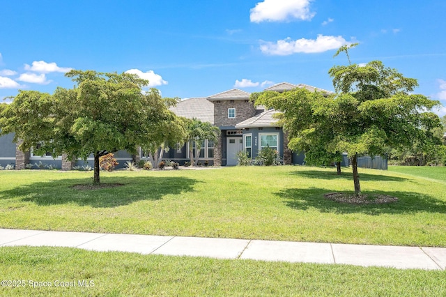 4554 Preservation Cir, Melbourne, FL 32934 - view of property hidden behind natural elements with a front lawn and a tile roof