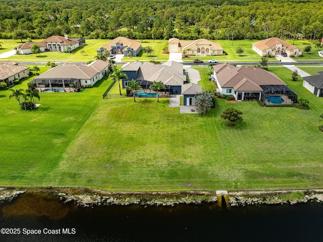 4554 Preservation Cir, Melbourne, FL 32934 - aerial view of residential area featuring a forest and a large body of water
