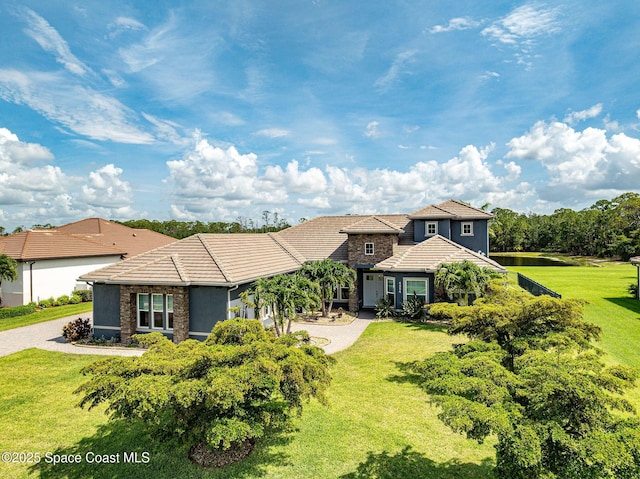 4554 Preservation Cir, Melbourne, FL 32934 - view of front of property with a tiled roof, a front yard, and driveway