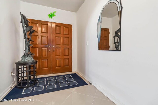 750 N Atlantic Ave Unit 203, Cocoa Beach, FL 32931 - tiled entrance foyer featuring baseboards