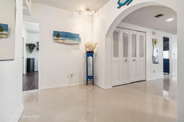 750 N Atlantic Ave Unit 203, Cocoa Beach, FL 32931 - tiled foyer entrance with arched walkways and baseboards
