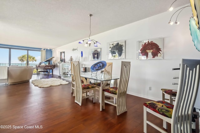 750 N Atlantic Ave Unit 203, Cocoa Beach, FL 32931 - dining space with wood finished floors and a textured ceiling