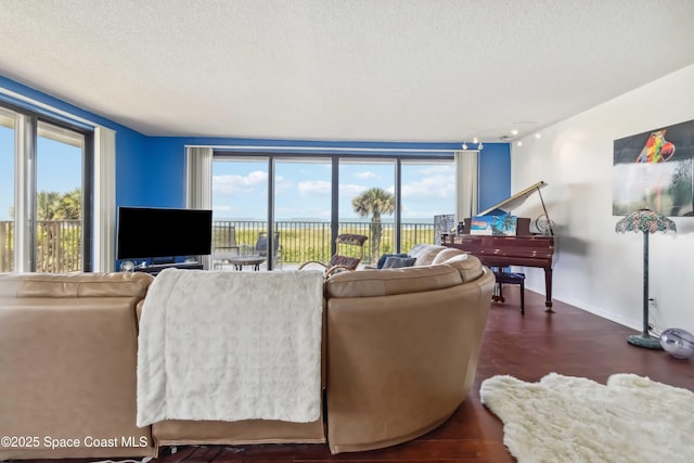 750 N Atlantic Ave Unit 203, Cocoa Beach, FL 32931 - living room featuring a textured ceiling and wood finished floors