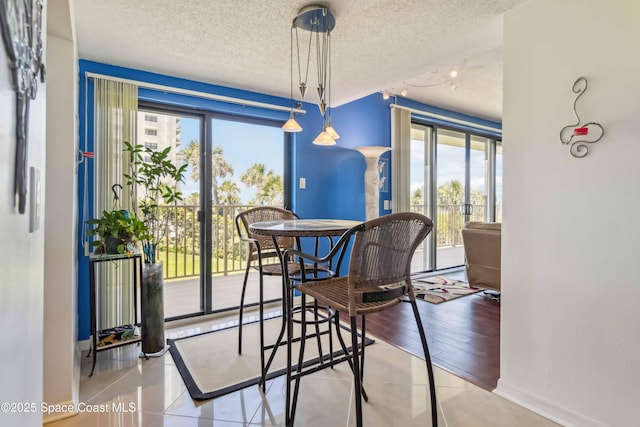 750 N Atlantic Ave Unit 203, Cocoa Beach, FL 32931 - tiled dining space with a textured ceiling and healthy amount of natural light
