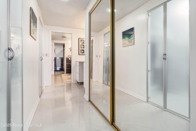 750 N Atlantic Ave Unit 203, Cocoa Beach, FL 32931 - hall featuring baseboards and light tile patterned flooring