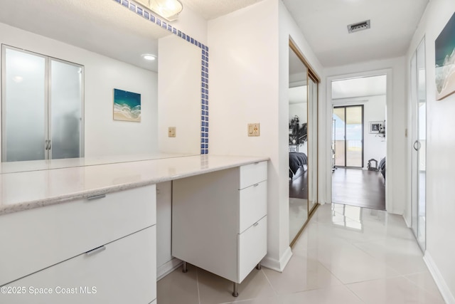 750 N Atlantic Ave Unit 203, Cocoa Beach, FL 32931 - laundry room featuring light tile patterned floors and recessed lighting