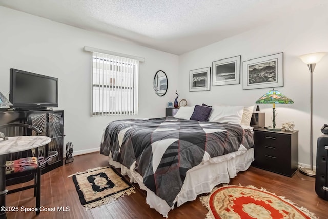 750 N Atlantic Ave Unit 203, Cocoa Beach, FL 32931 - bedroom featuring wood finished floors and a textured ceiling